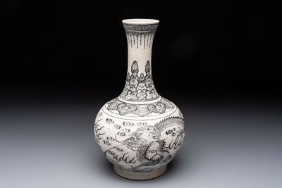 A Chinese black-enamelled biscuit 'dragon' vase, Kangxi mark, 19th C.
