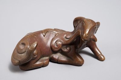 A Chinese bronze scroll or paper weight shaped as a ram, 17/18th C.