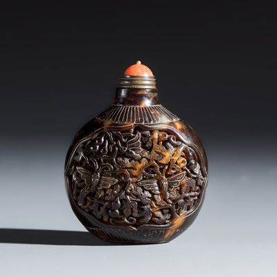 A Chinese carved tortoiseshell snuff bottle with butterflies among double-gourd vines, 19th C.