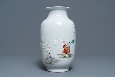 A Chinese famille rose relief-decorated vase with playing boys, Qianlong mark, Republic, 20th C.