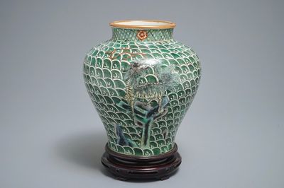 A Chinese famille verte vase with mythical beasts on a ground of waves, 19th C.