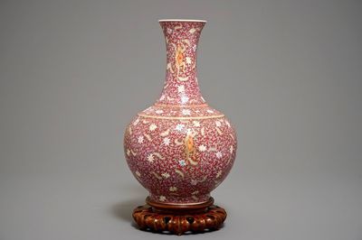 A Chinese ruby-ground famille rose bottle vase with dancing boys, Qianlong mark, 19/20th C.