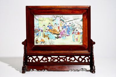 A Chinese wooden table screen with a famille rose plaque, 20th C.