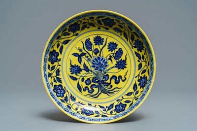 A Chinese yellow-ground blue and white 'lotus bouquet' plate, Qianlong mark, 19/20th C.
