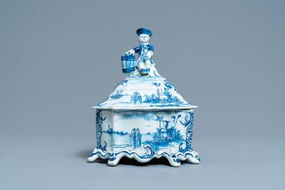 A Dutch Delft blue and white tobacco box and cover with a boy near a barrel, 18th C.