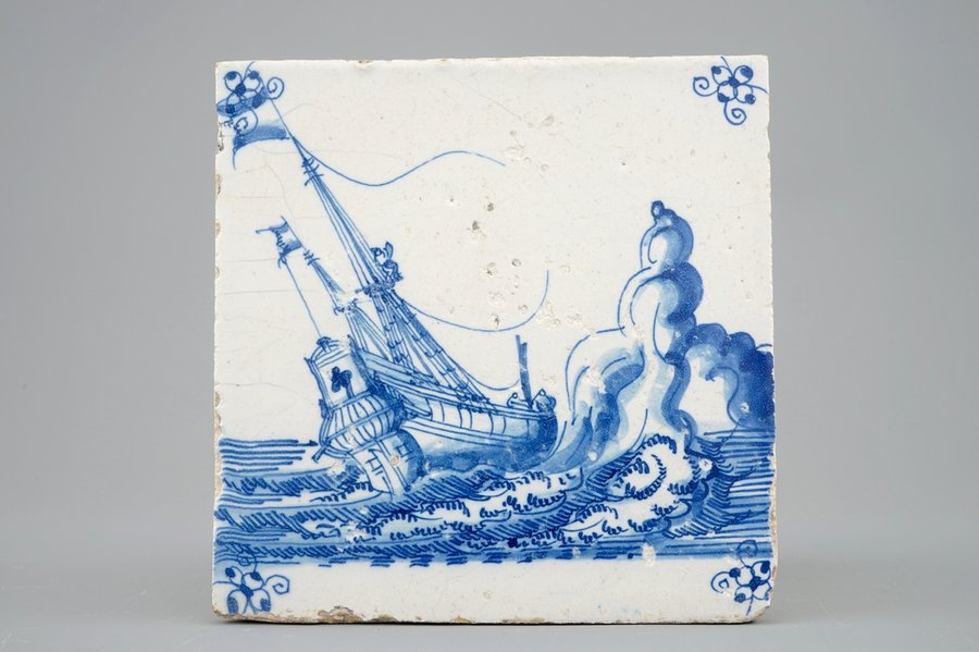 A Dutch Delft tile with a ship near rocks, late 17th C.