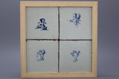 A framed set of 4 Dutch Delft tiles with amors 17th C.
