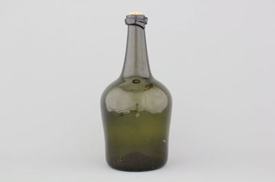 A large green glass free-blown wine bottle, 18th C.