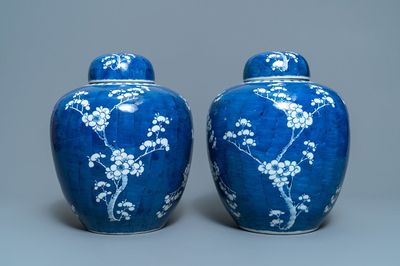 A pair of Chinese blue and white 'prunus on cracked ice' jars and covers, 19th C.
