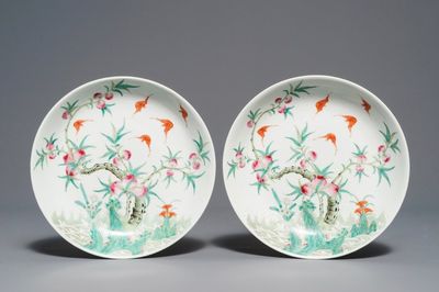 A pair of Chinese famille rose 'bats and peaches' plates, Republic, 20th C.