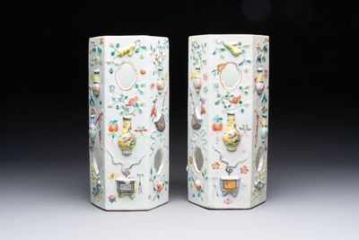 A pair of Chinese famille rose relief-moulded reticulated 'antiquities' hat stands, 19th C.