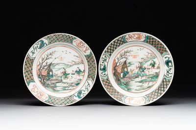 A pair of Chinese famille verte plates with figures along the riverside, artemisia leaf and ding mark, Kangxi