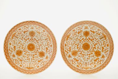 A pair of Chinese iron red chargers with floral design, 19/20th C.