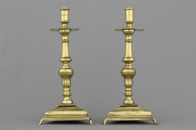 A pair of Spanish bronze candlesticks on triangular bases, 17th C.
