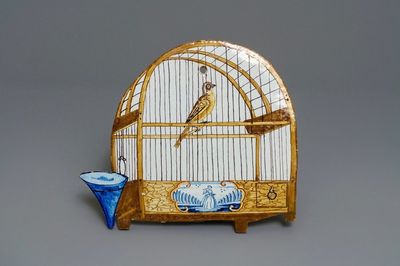 A polychrome Dutch Delft trompe l'oeil birdcage plaque, 18th C.