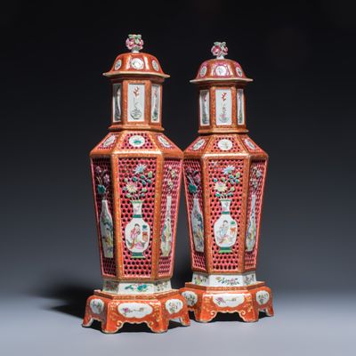 A rare pair of Chinese famille rose reticulated double-walled covered vases and stands, Yonzgheng/Qianlong