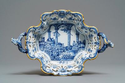 A reticulated Dutch Delft blue and white basket with a view on a wine cellar, 18th C.