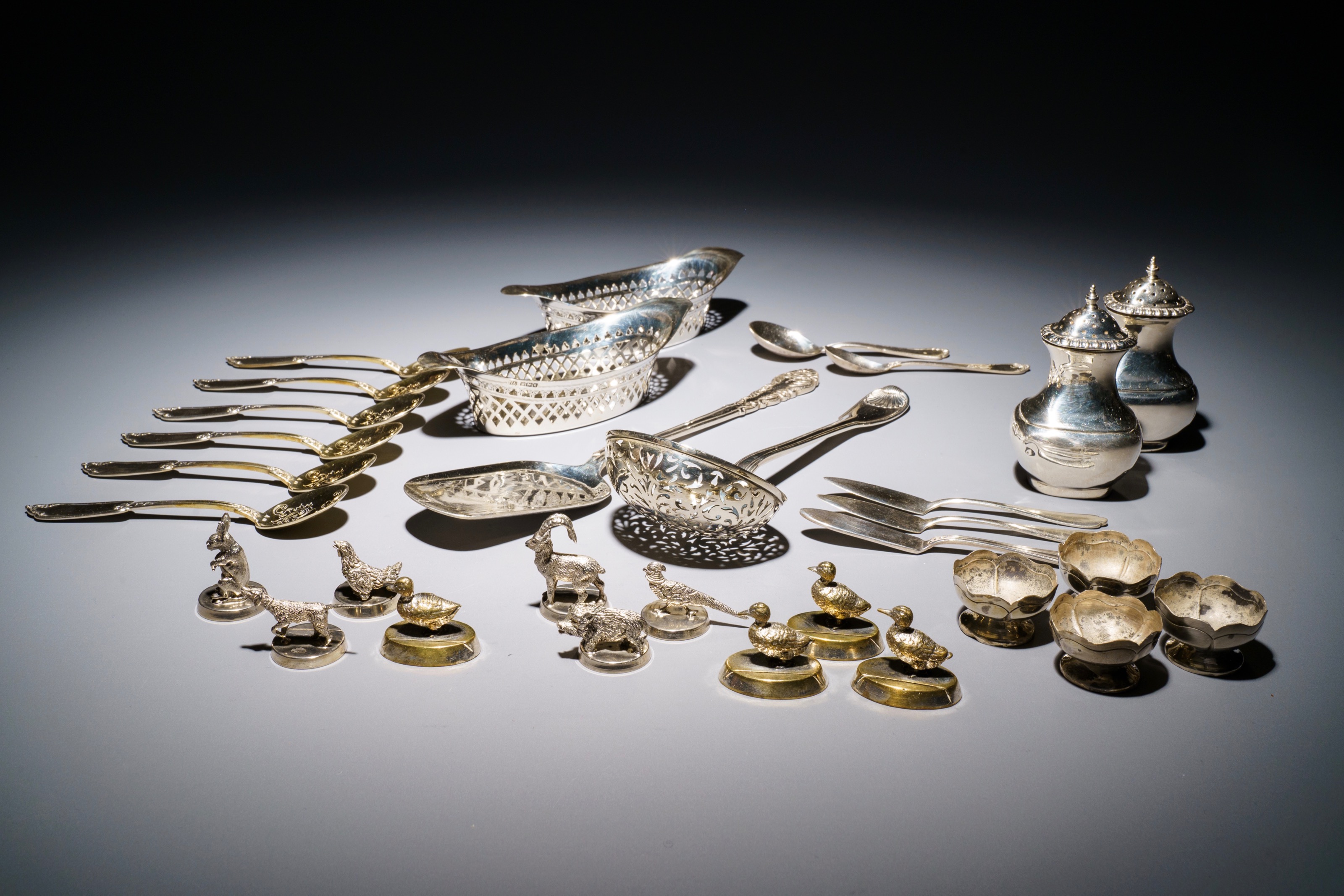 A varied collection of small silverware and ten silverplated menu