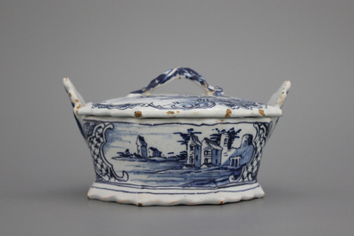 A fine Dutch Delft blue and white butter tub with landscape painting, 18th C.