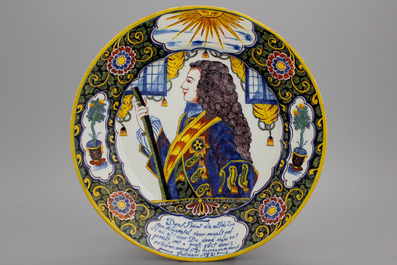 An important commemorative royalist Dutch Delft portrait dish with mixed technique border, reinforced with black and dated ca. 1752