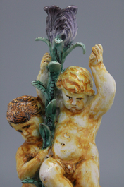 A pair of Spanish Talavera candlesticks with putti on a branch, 18th C.