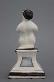 A French ceramic figure of a boy on a base, 18th C.