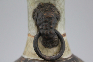 A Chinese crackle glazed bottle vase with elephant handles, 19th C.