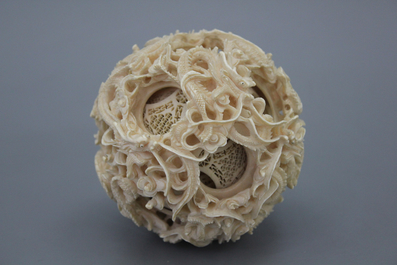 A large Chinese carved ivory puzzle ball on stand, 1st half 20th C.