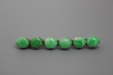 A set of Chinese jade jewellery: a bangle, a brooch and a bracelet