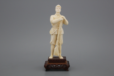 A fine Chinese carved ivory figure of a soldier with a gun, Cultural revolution, 20th C.