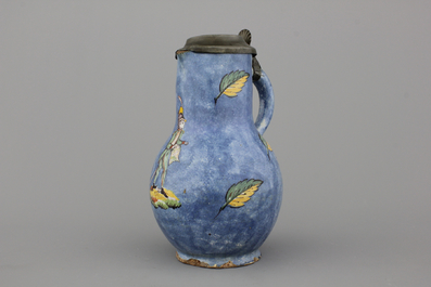 A rare Brussels faience blue ground jug with a soldier, 18th C.