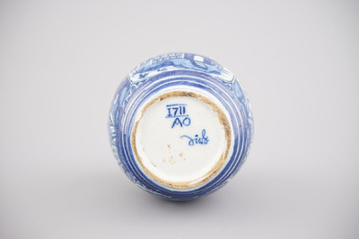 A rare dated Dutch Delft blue and white chinoiserie barrel-shaped spirit bottle, ca. 1711