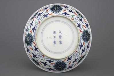 A Chinese porcelain doucai lotus scroll plate, 19th C.