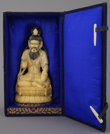 A Chinese carved ivory figure of a seated Luohan, 19/20th C.