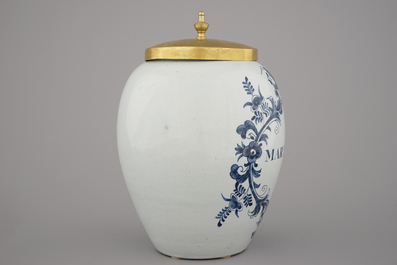A Dutch Delft tobacco jar with brass lid, &quot;Martiniek&quot; 18th C.