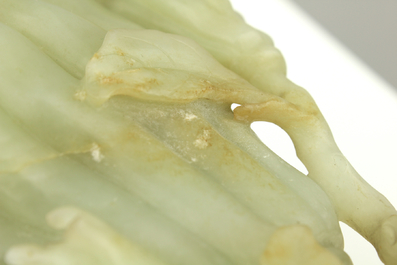 A jade buddha hand on a carved wood stand, Qing dynasty, 18th C.