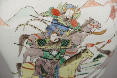 A Chinese porcelain wucai vase and cover depicting warriors on horseback, 19th C.