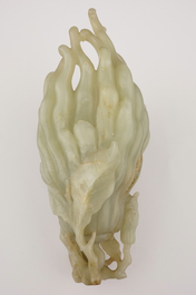 A jade buddha hand on a carved wood stand, Qing dynasty, 18th C.