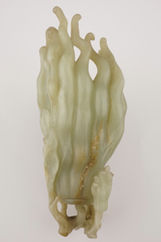 A jade buddha hand on a carved wood stand, Qing dynasty, 18th C.