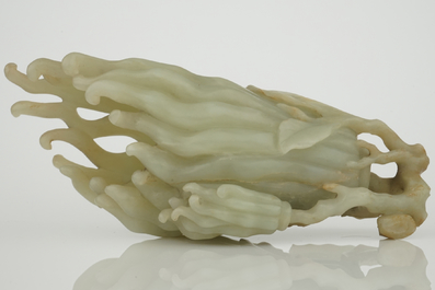 A jade buddha hand on a carved wood stand, Qing dynasty, 18th C.