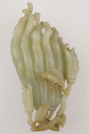 A jade buddha hand on a carved wood stand, Qing dynasty, 18th C.