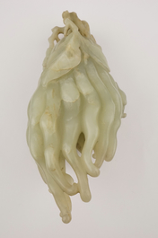 A jade buddha hand on a carved wood stand, Qing dynasty, 18th C.