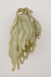 A jade buddha hand on a carved wood stand, Qing dynasty, 18th C.