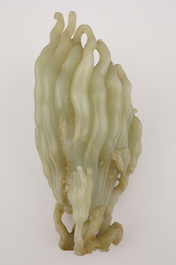 A jade buddha hand on a carved wood stand, Qing dynasty, 18th C.