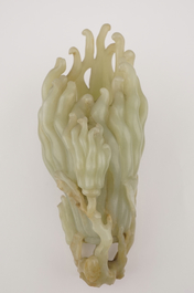 A jade buddha hand on a carved wood stand, Qing dynasty, 18th C.