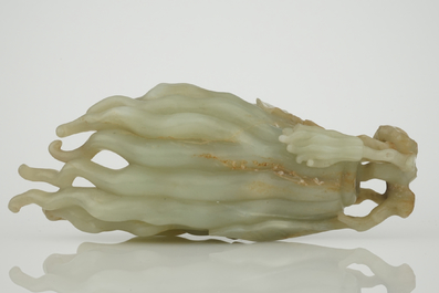 A jade buddha hand on a carved wood stand, Qing dynasty, 18th C.