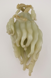 A jade buddha hand on a carved wood stand, Qing dynasty, 18th C.