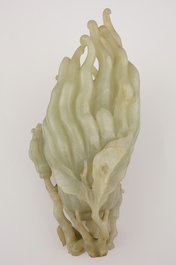 A jade buddha hand on a carved wood stand, Qing dynasty, 18th C.