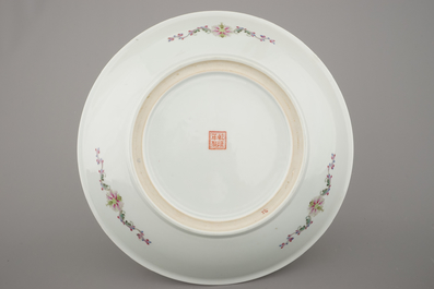 A fine large Chinese porcelain charger with ladies in a garden, 20th C.