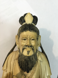 A Chinese carved ivory figure of a seated Luohan, 19/20th C.